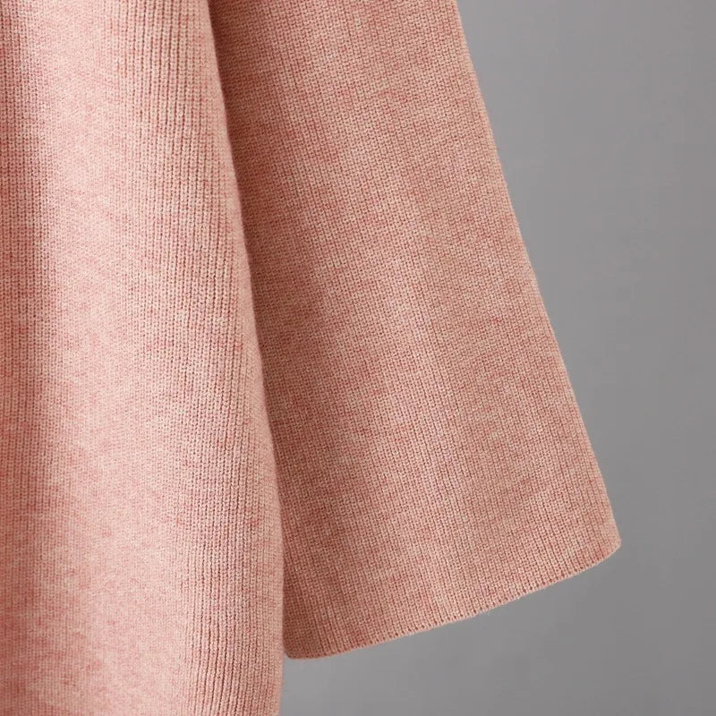"Elegant Turtleneck Sweater with Asymmetrical Cut and Tailored Trousers"