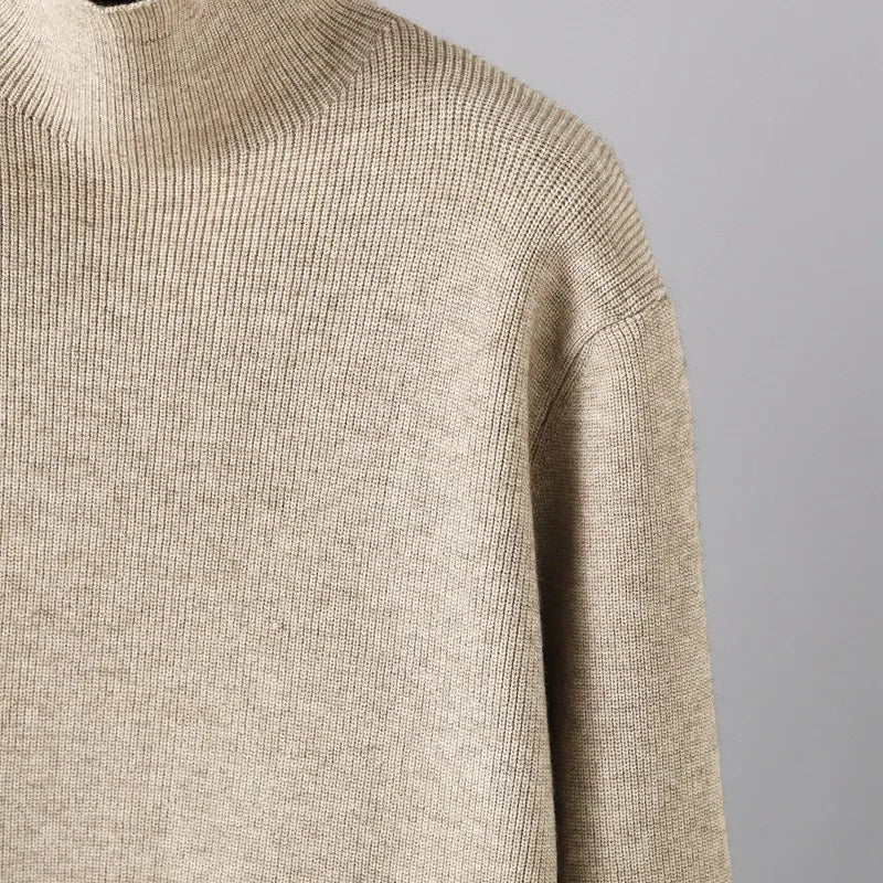 "Elegant Turtleneck Sweater with Asymmetrical Cut and Tailored Trousers"